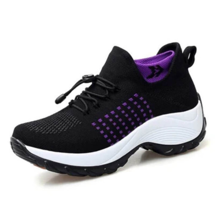 black slip-on sneakers with purple stripe accents and thick white sole