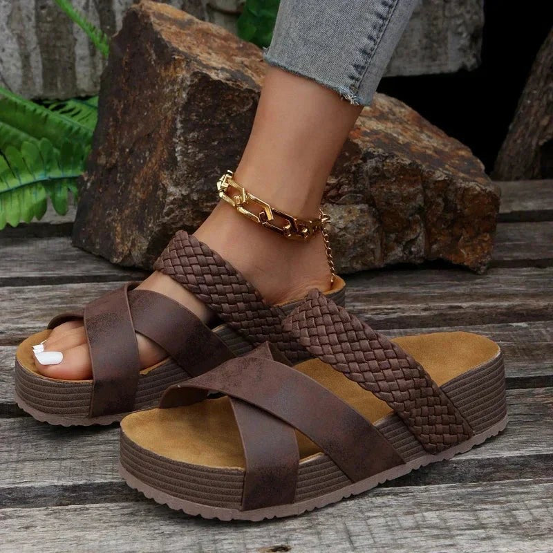 Brown crisscross platform sandals styled with gold anklet outdoors