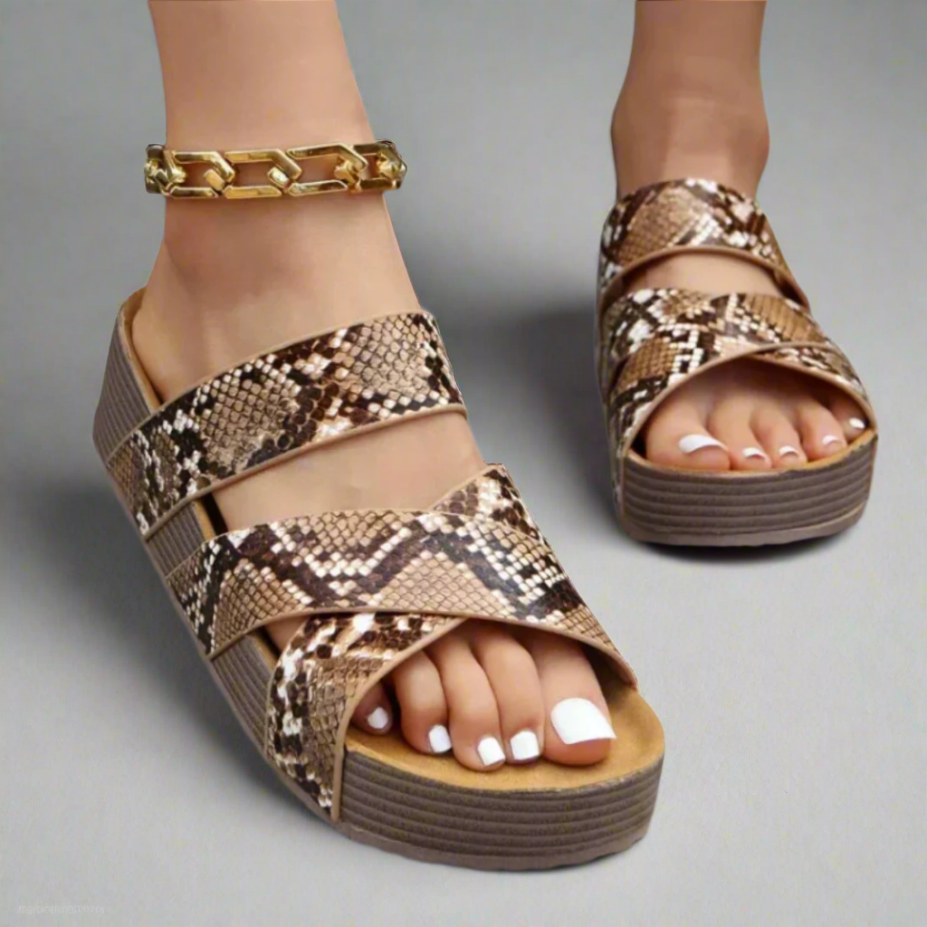 Snakeskin print crisscross platform sandals worn with gold chain anklet