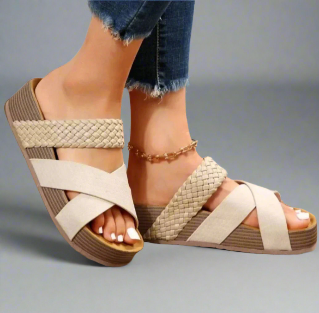 Cream woven crisscross platform sandals paired with distressed denim jeans