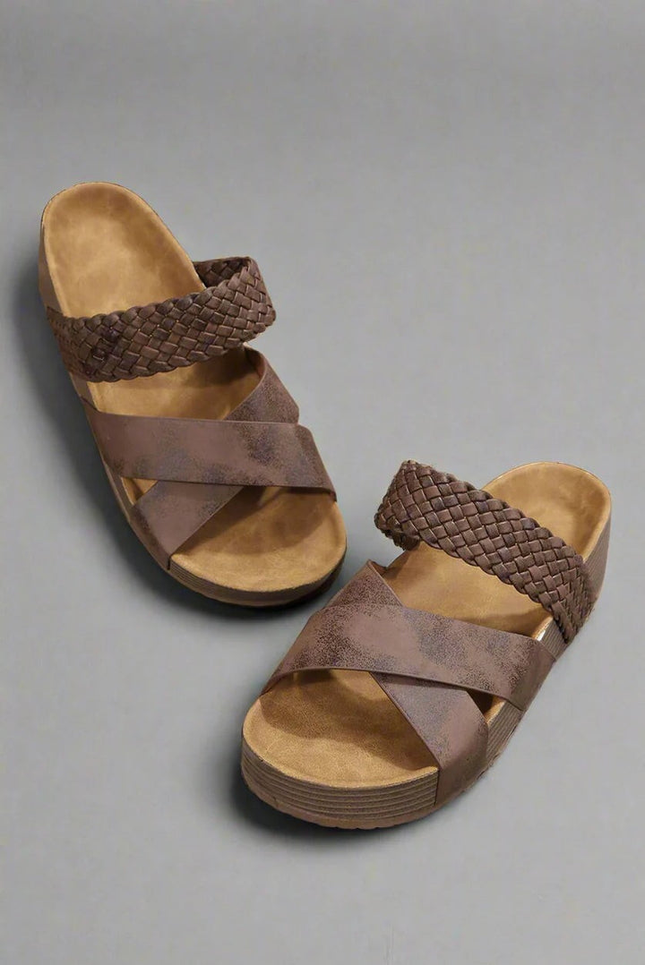 Brown woven crisscross platform sandals shown in a flat lay pair