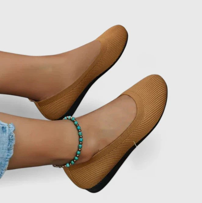 camel knit ballet flats worn on feet with ribbed texture