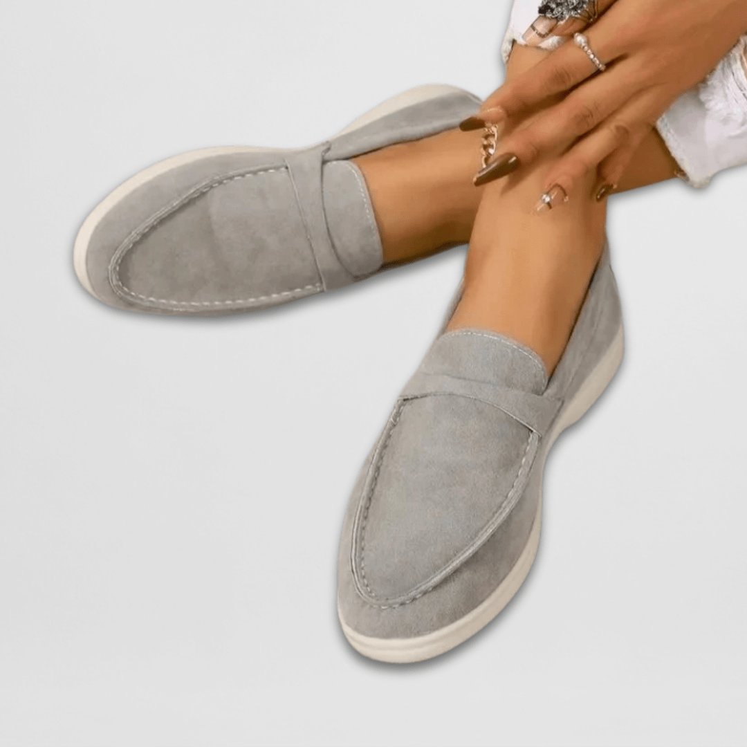 Gray suede penny loafers with white contrast stitching and thick sole