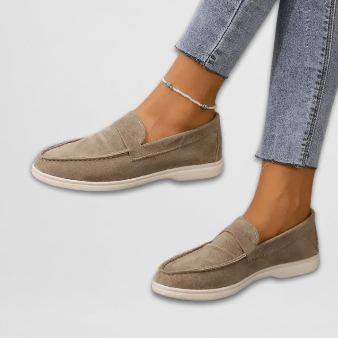 Taupe suede penny loafers styled with cropped denim jeans
