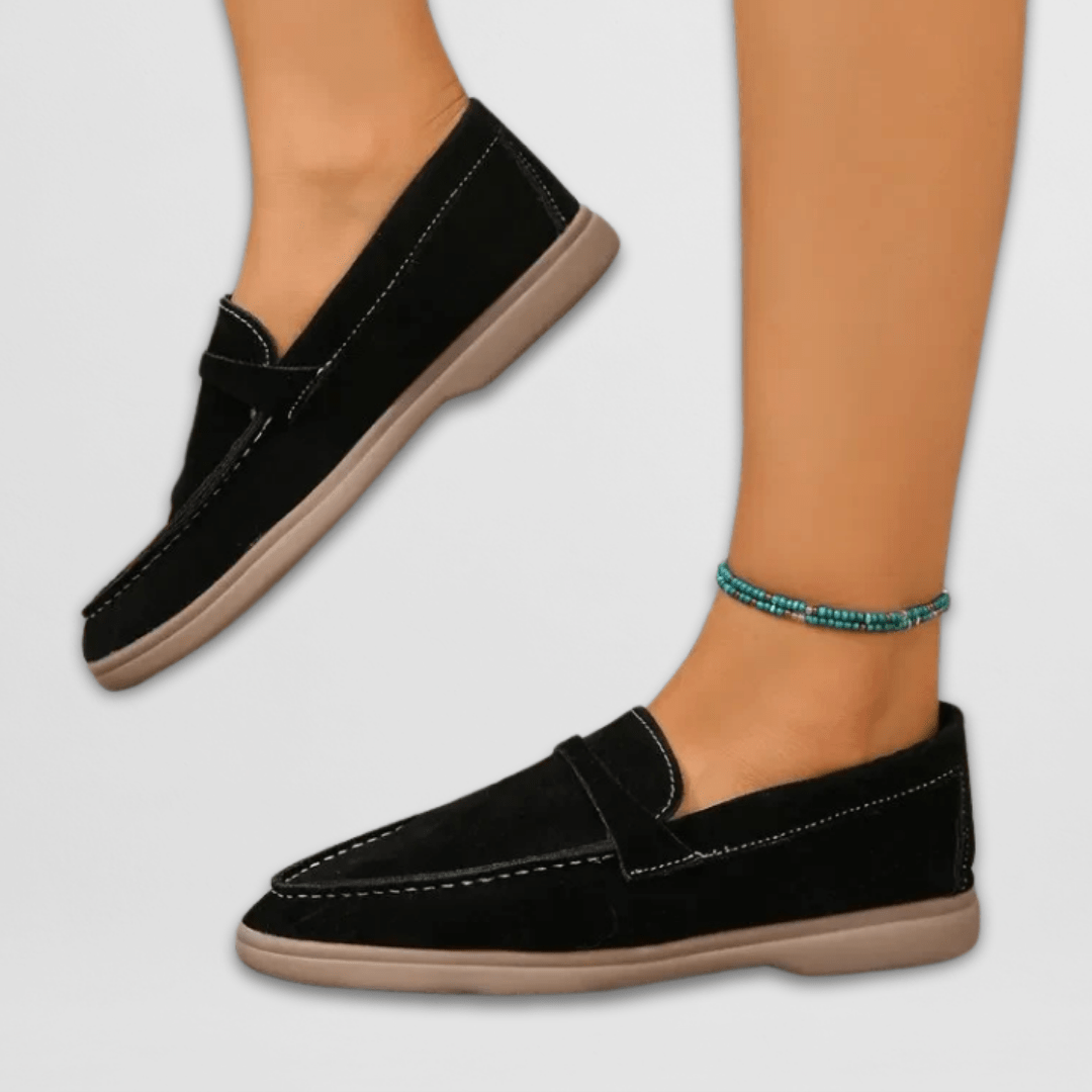 Black suede penny loafers with tan sole and contrast stitching