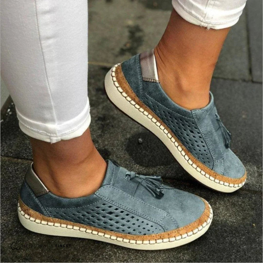 blue suede slip-on walking sneakers with cork trim and tassel accent