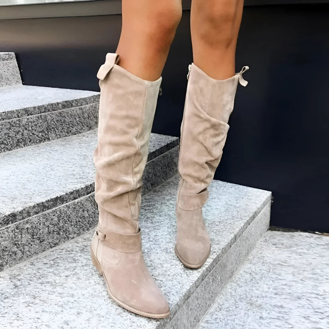 beige suede slouch boots with buckle detail worn on steps
