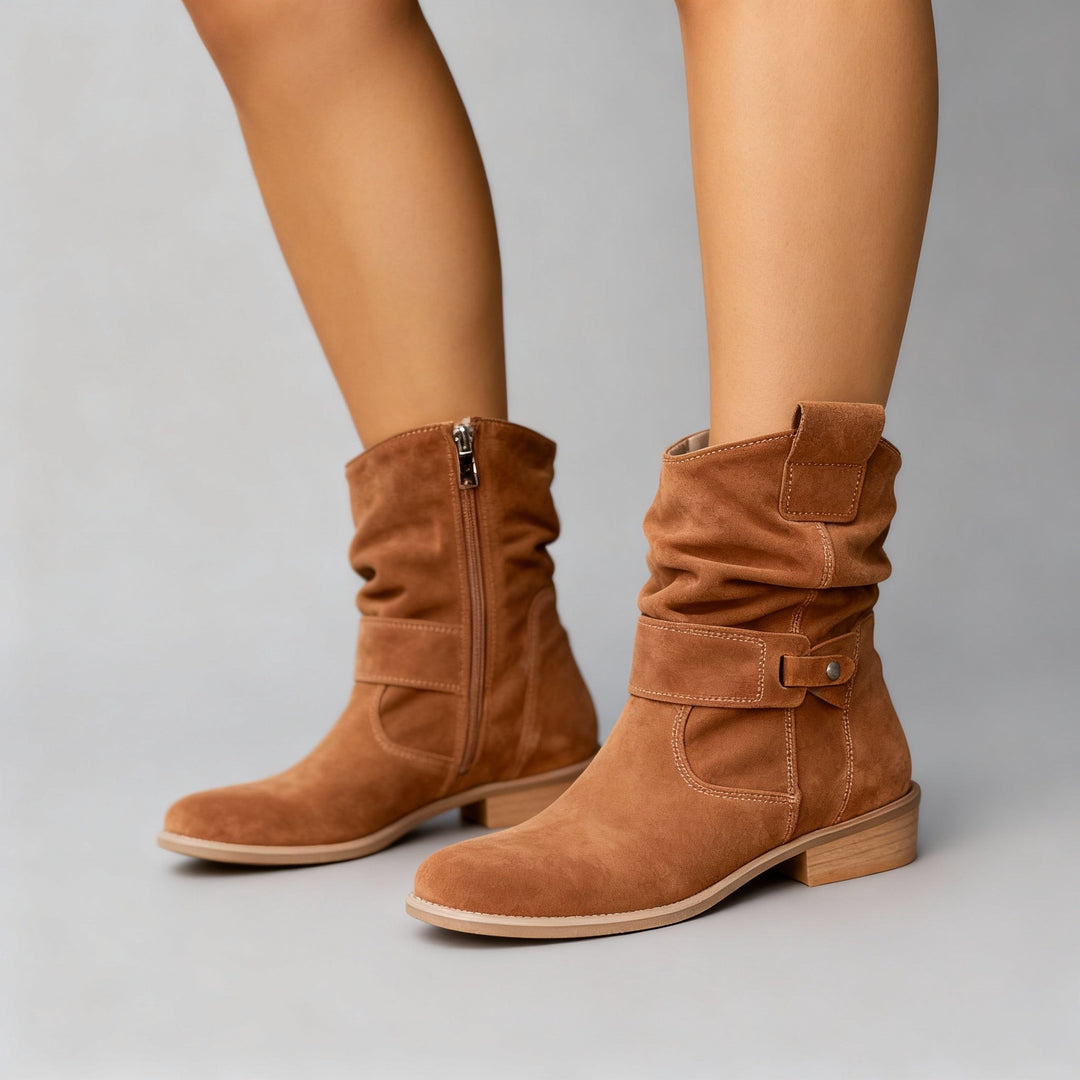 Tan suede slouchy boots featuring side zip and stacked block heel