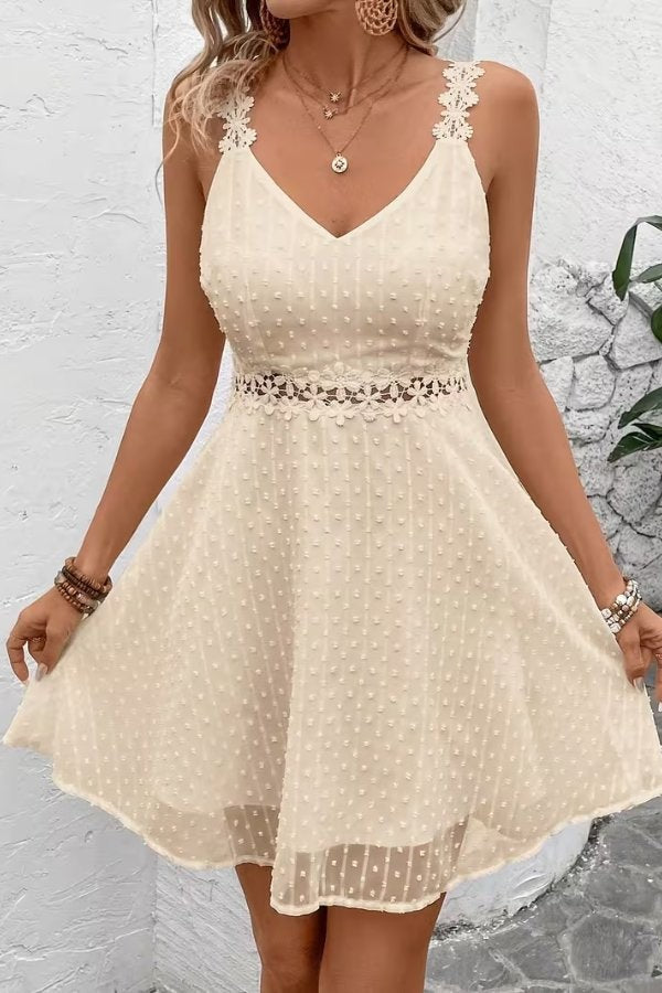 Front view of ivory swiss dot dress with floral lace waist detail