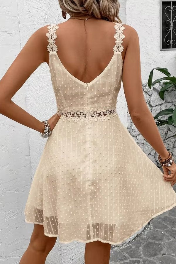 Back view of cream lace-waist mini dress with crochet shoulder straps