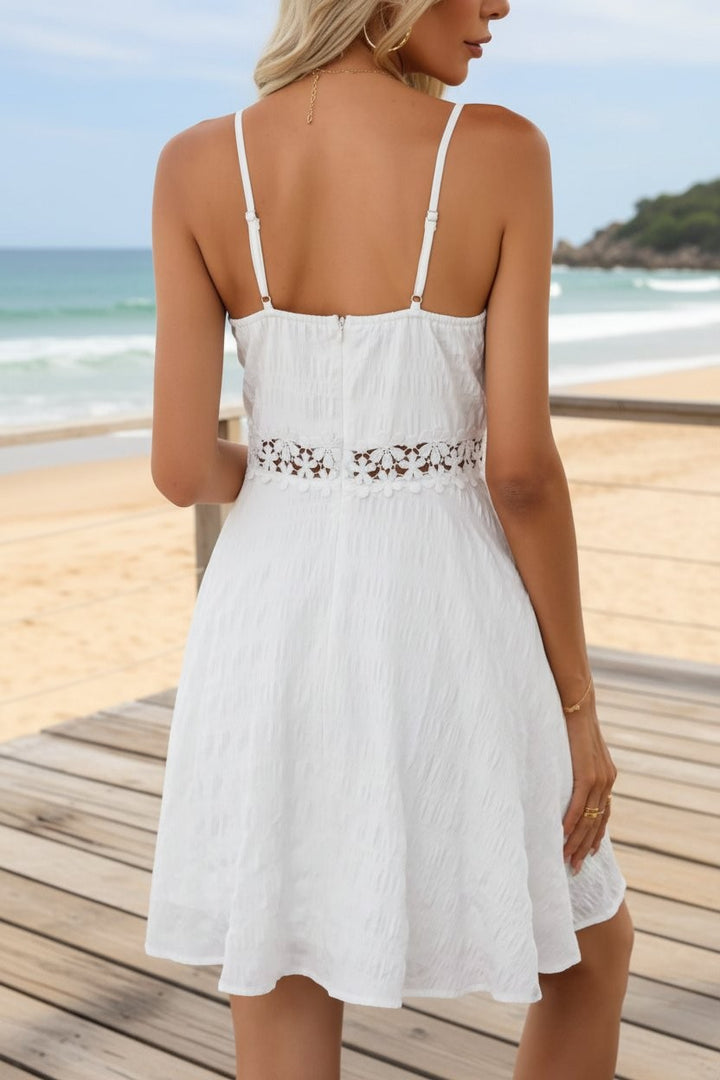 Back view of white spaghetti strap dress with lace waist on boardwalk