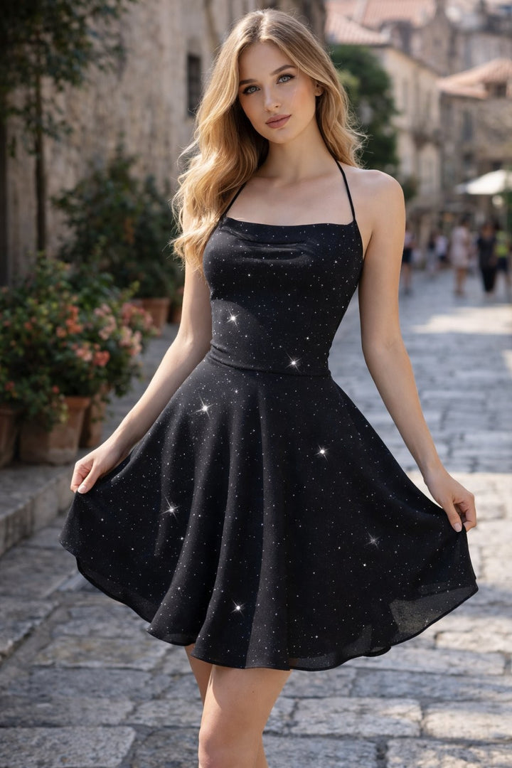 Black glitter halter-neck fit-and-flare cocktail dress on cobblestone street