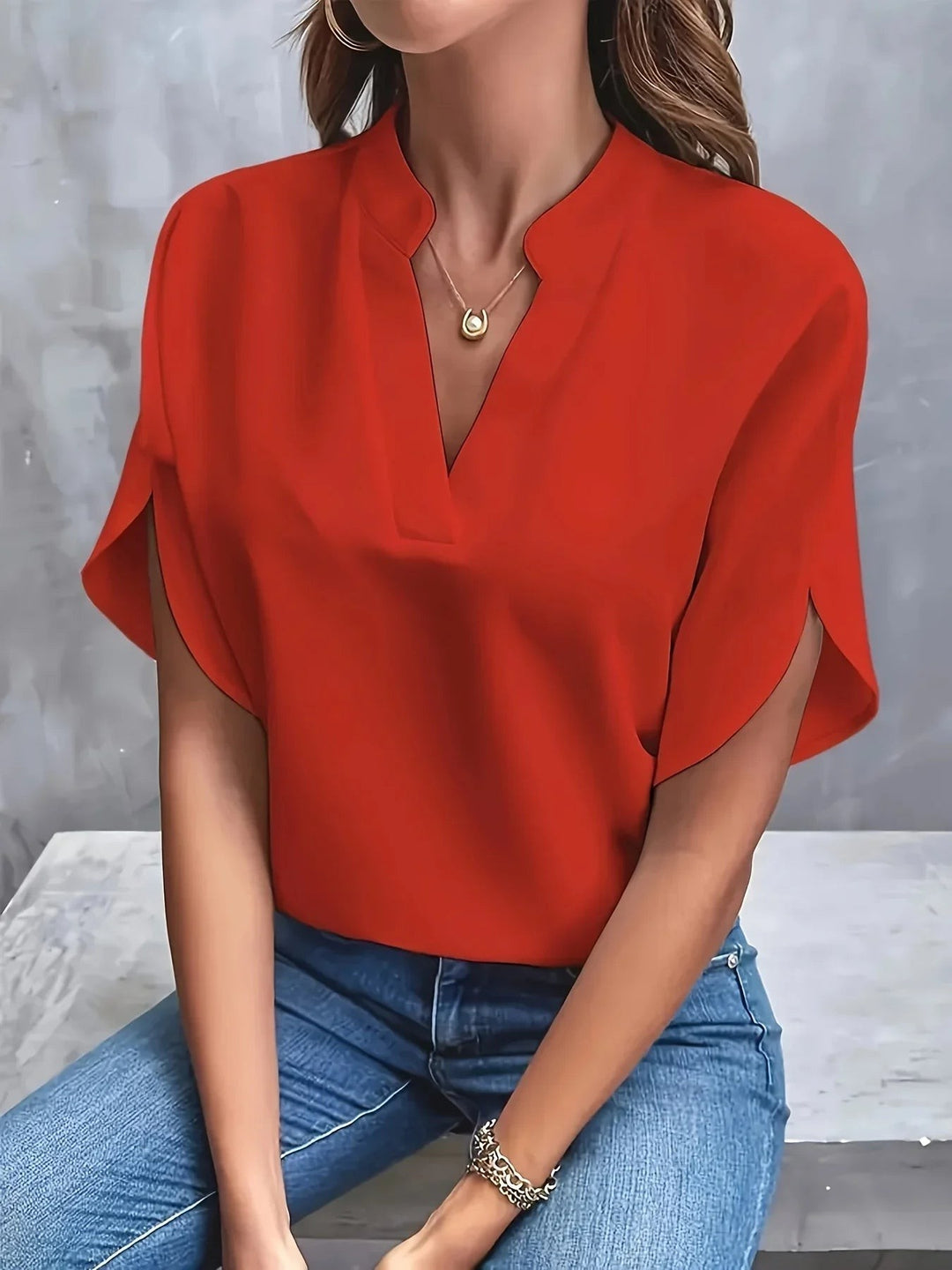 Red split-sleeve blouse with notched V-neck and elegant flowing sleeves
