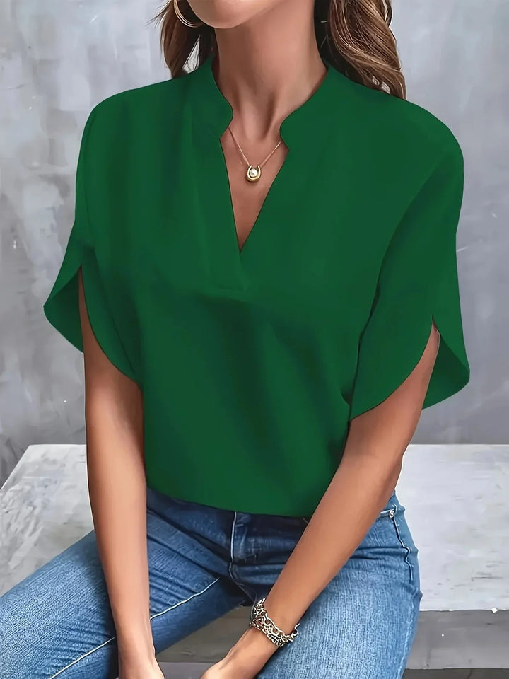 Green split-sleeve blouse with notched V-neck and tailored batwing sleeves