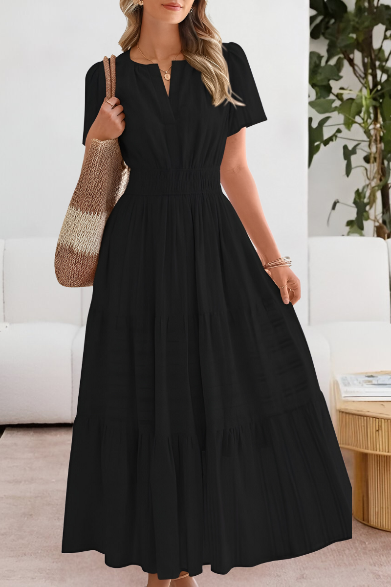 black tiered maxi dress featuring smocked waist and short sleeves