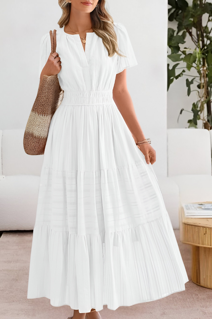 white tiered maxi dress featuring split neckline and puff sleeves