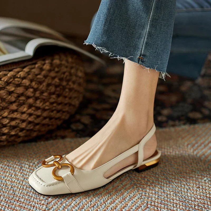 Cream leather slingback flats featuring gold buckle and square toe design