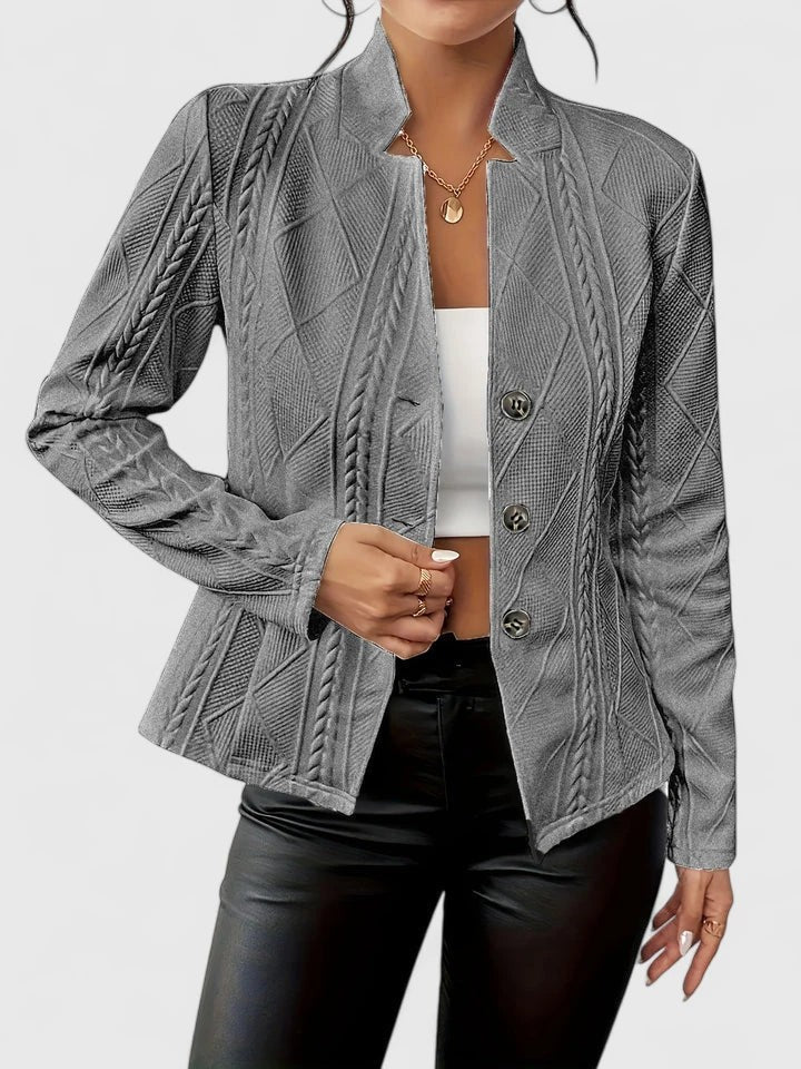 Grey textured fitted blazer with stand collar, styled with black trousers