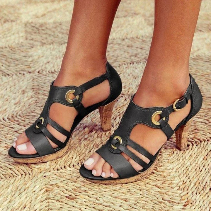 black leather gladiator sandals with gold grommets and cork heel