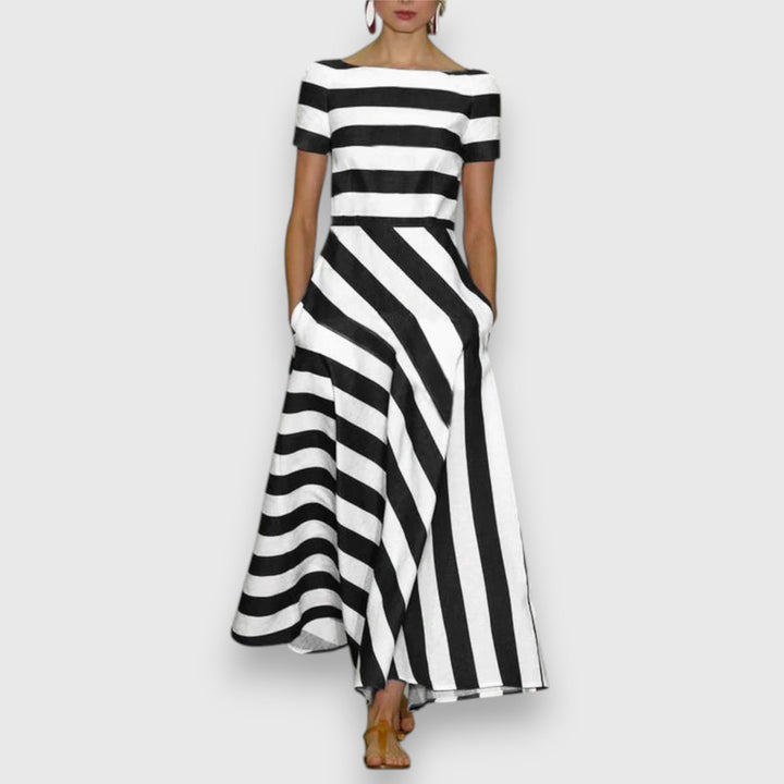 Black and white striped maxi dress with boat neckline and asymmetric hemline