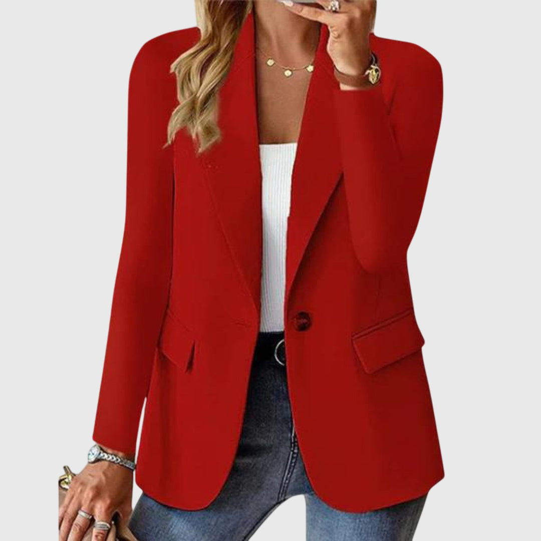 Red single-button blazer with notch lapel, worn open over a white top