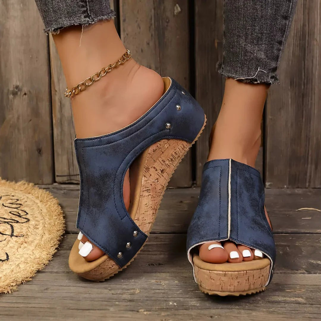Navy blue studded cork wedge sandals featuring open-toe cutout style