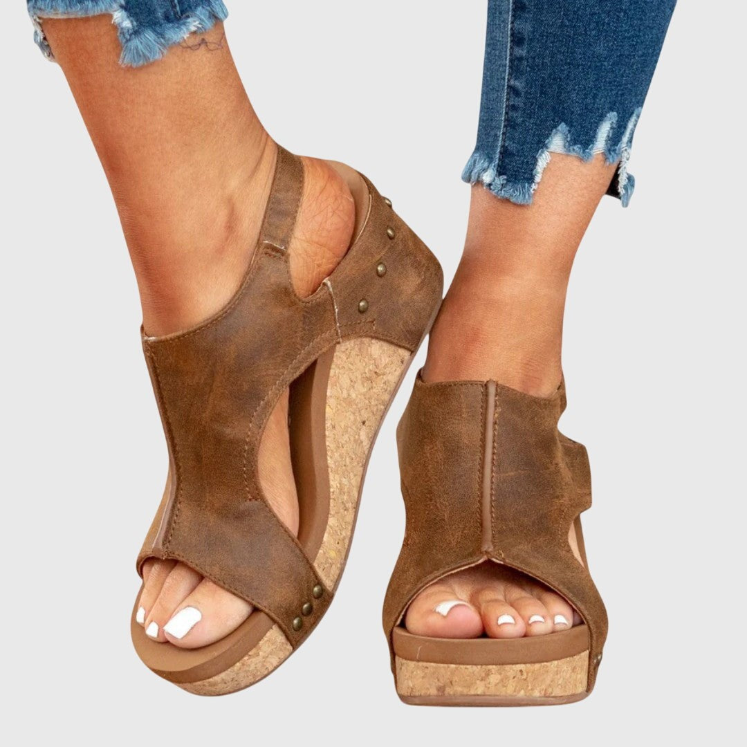 Studded brown wedge sandals with cutout sides and slingback strap