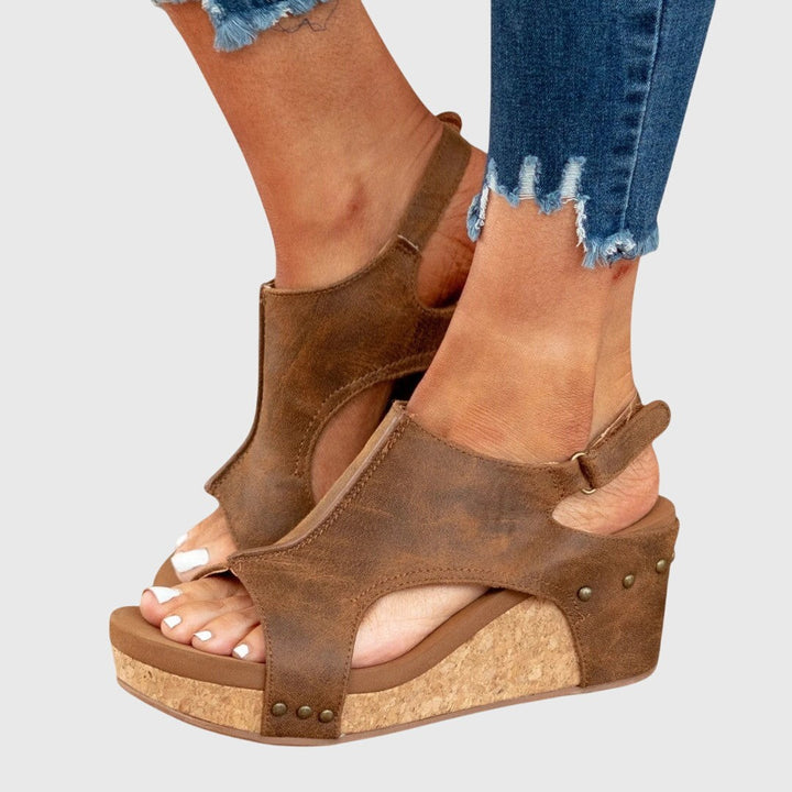 Brown cork wedge sandals featuring ankle strap and open peep toe