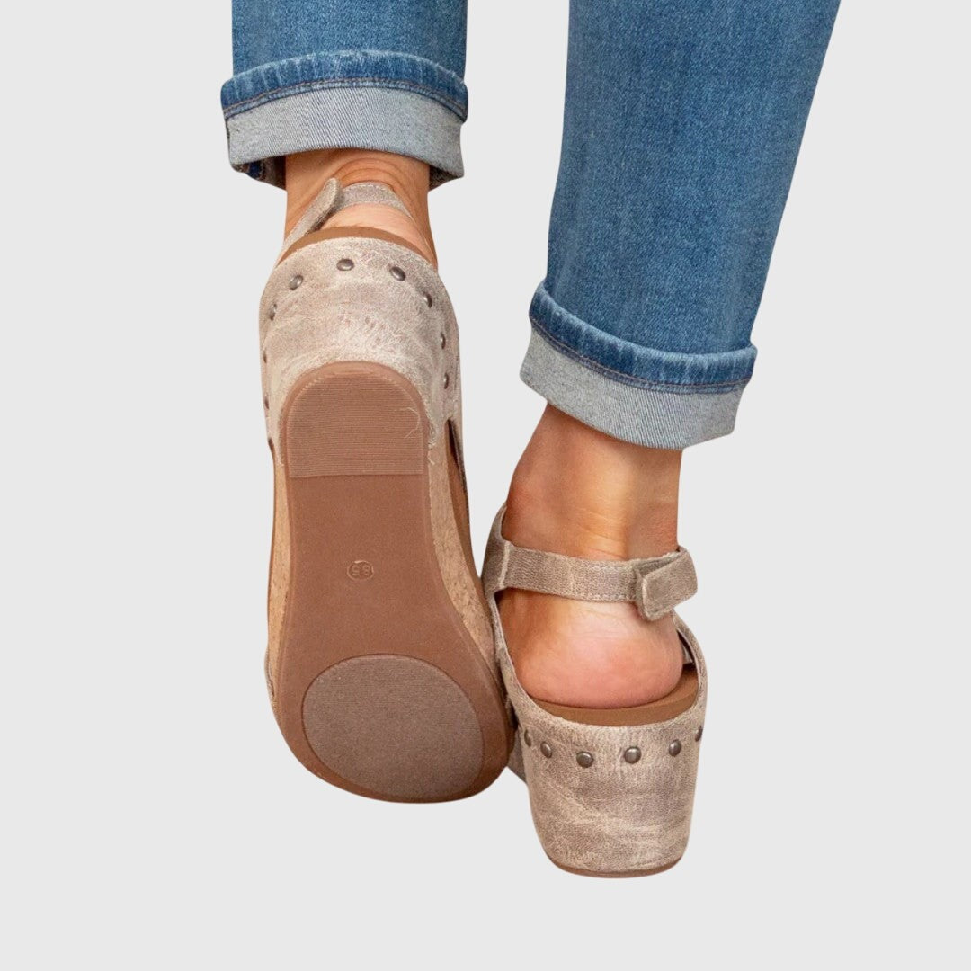 Taupe cork wedge sandal sole showing rubber tread and studded heel counter