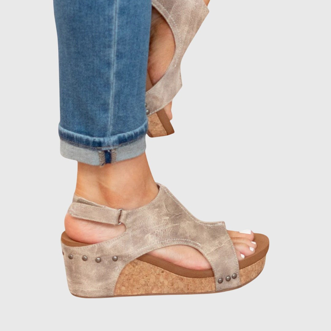 Side view of taupe wedge sandal with ankle strap and cork platform
