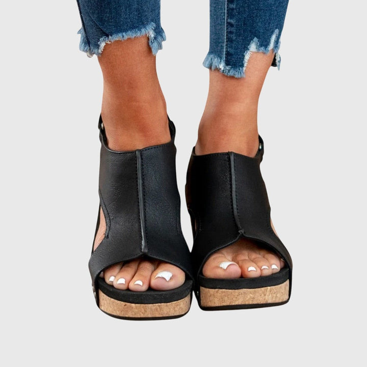 Black leather wedge sandals with peep toe and cork sole detail