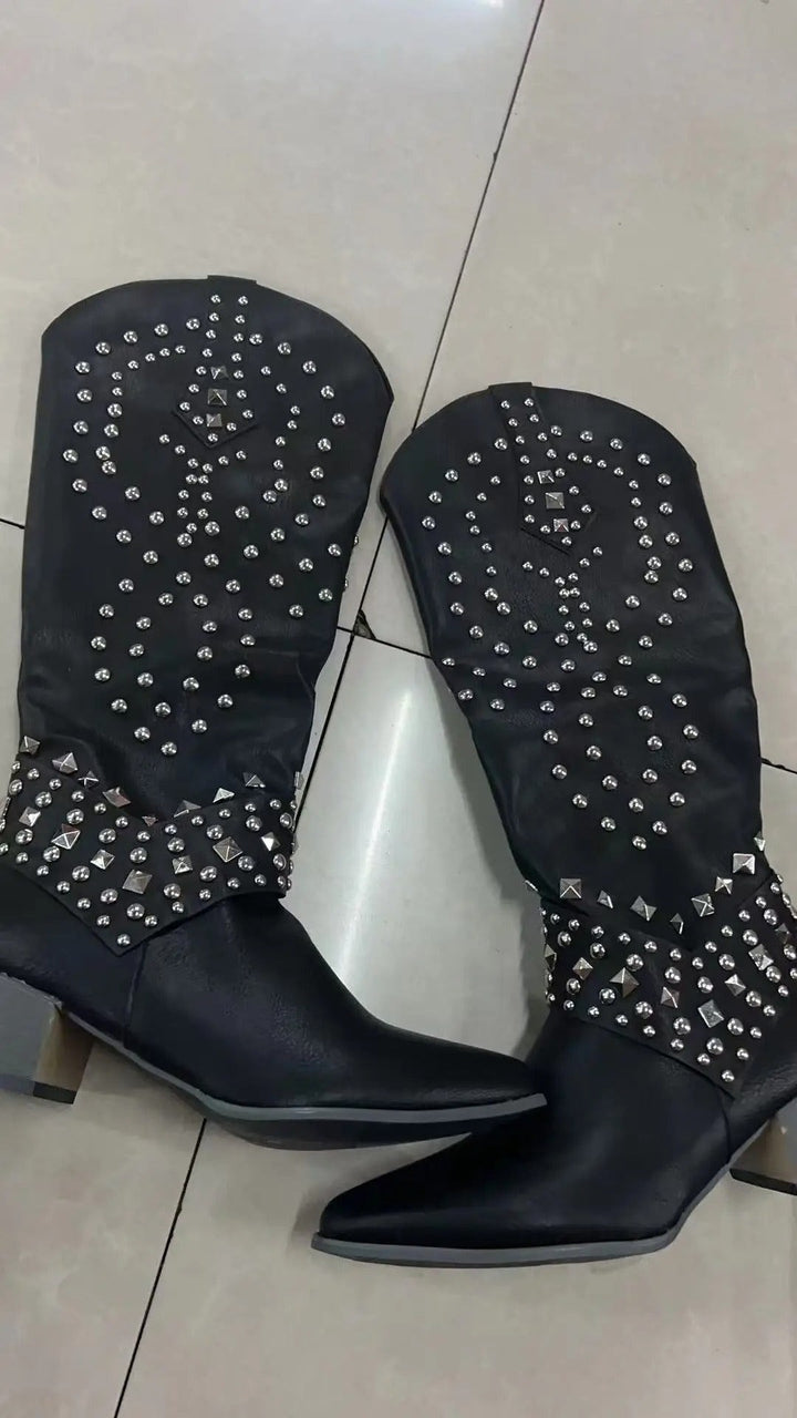 Black studded knee-high cowboy boots featuring pointed toe and stacked heel
