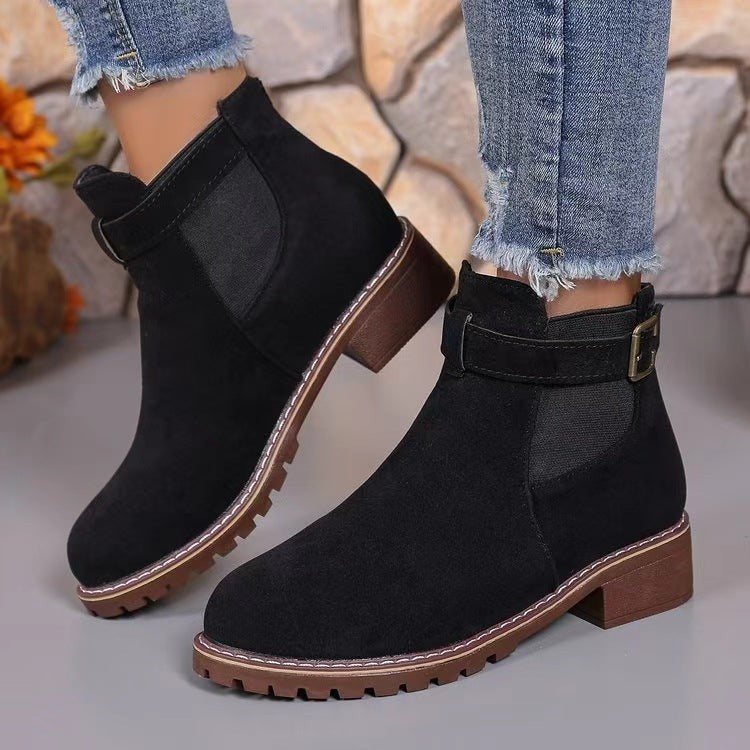 Black suede ankle boots with buckle strap and durable tread sole