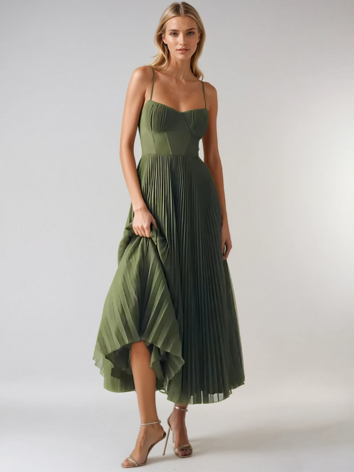 Model wearing olive pleated maxi dress with high-low hem and thin straps