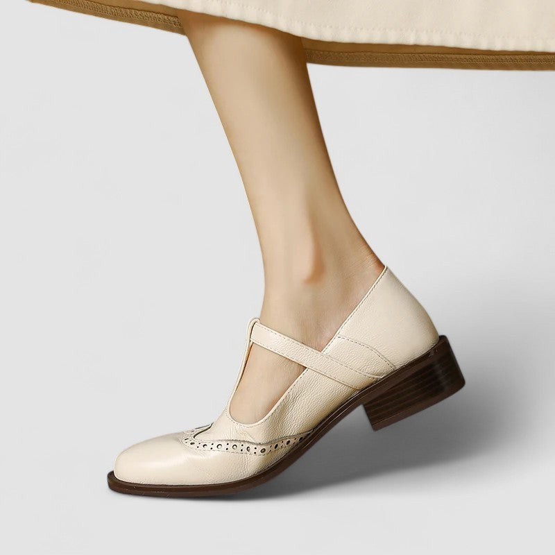Cream leather T-strap Mary Janes with crisscross ankle strap styling