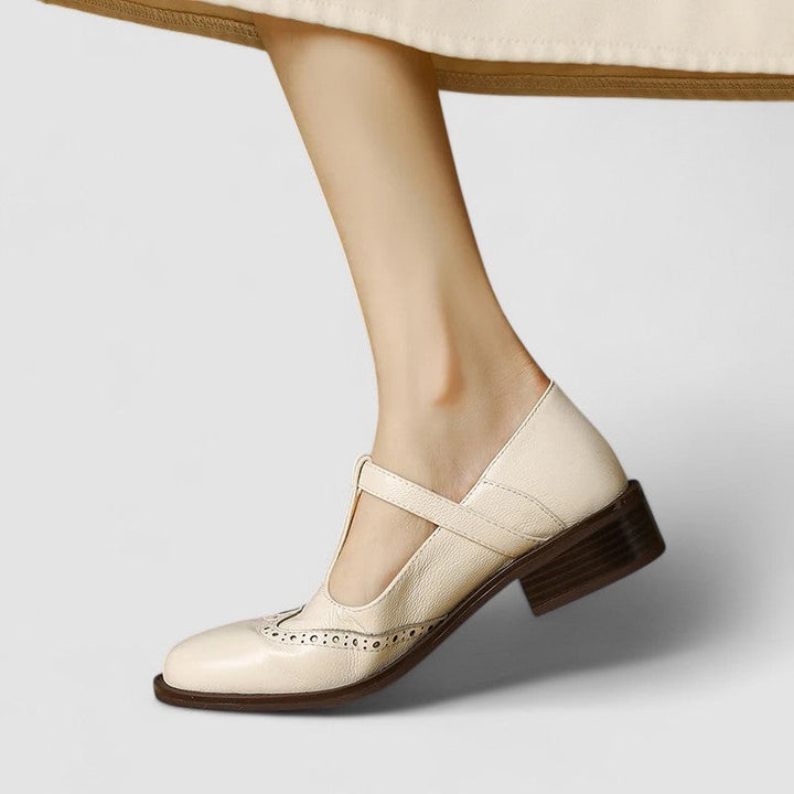 Cream leather T-strap Mary Janes with crisscross ankle strap styling