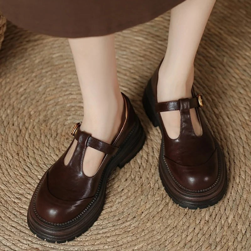 Model wearing brown T-bar Mary Jane shoes with chunky platform soles