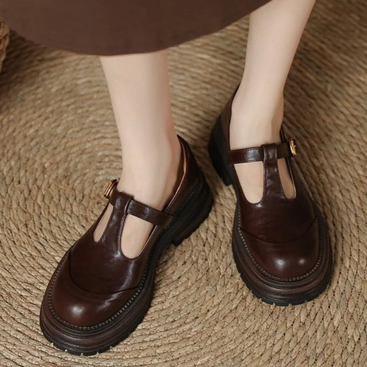 Model wearing brown T-bar Mary Jane shoes with chunky platform soles