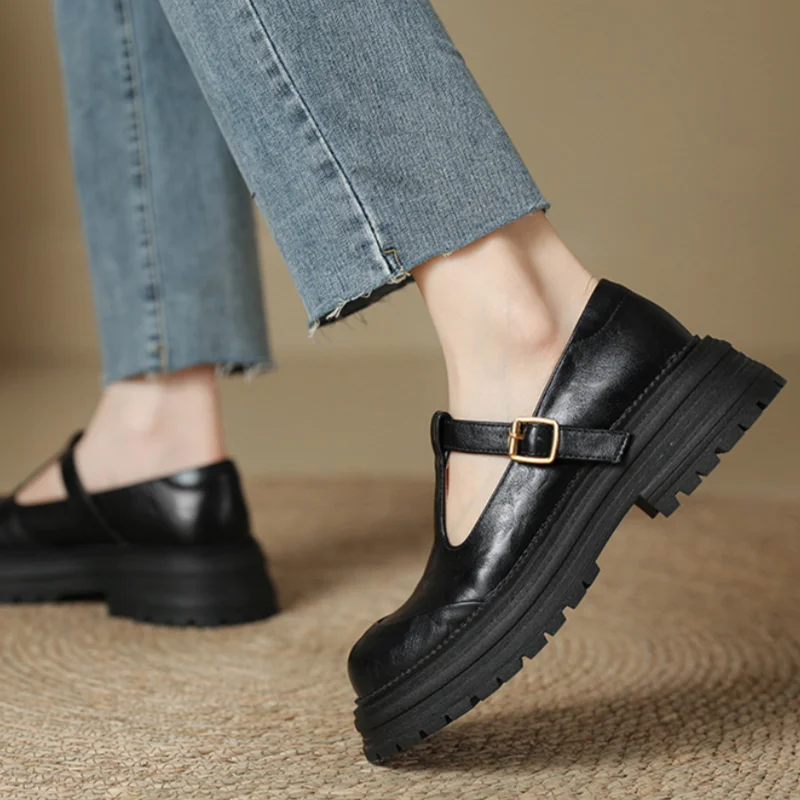 Black leather T-strap Mary Jane shoe styled with cropped denim jeans