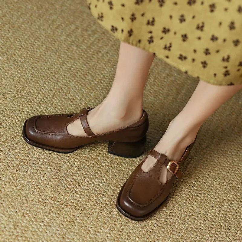 Pair of brown T-strap Mary Janes worn with floral midi dress