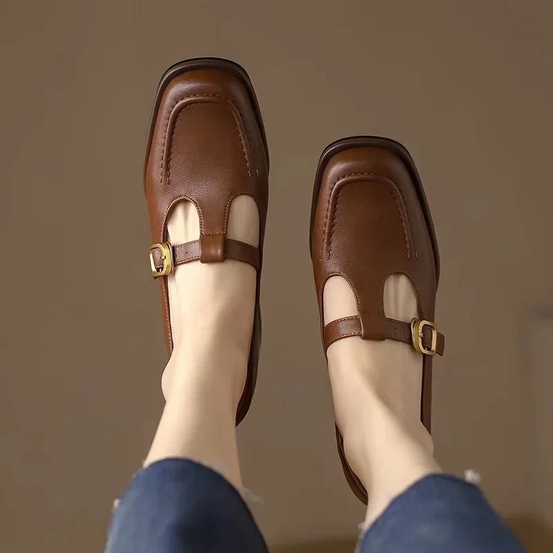 Overhead view of brown square-toe Mary Jane flats with buckle strap