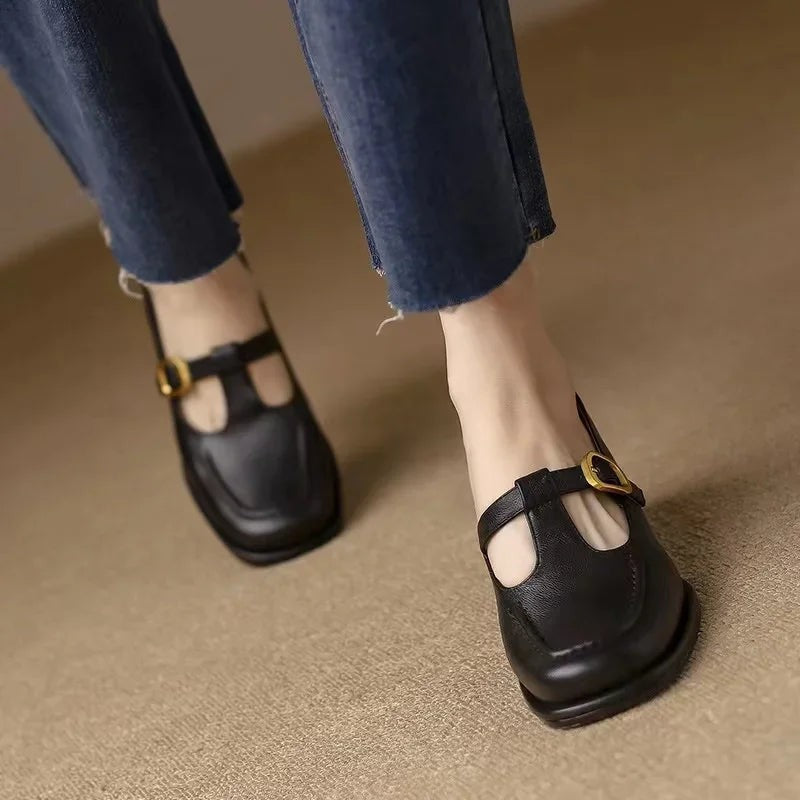 Black T-strap Mary Jane shoes paired with cropped denim jeans
