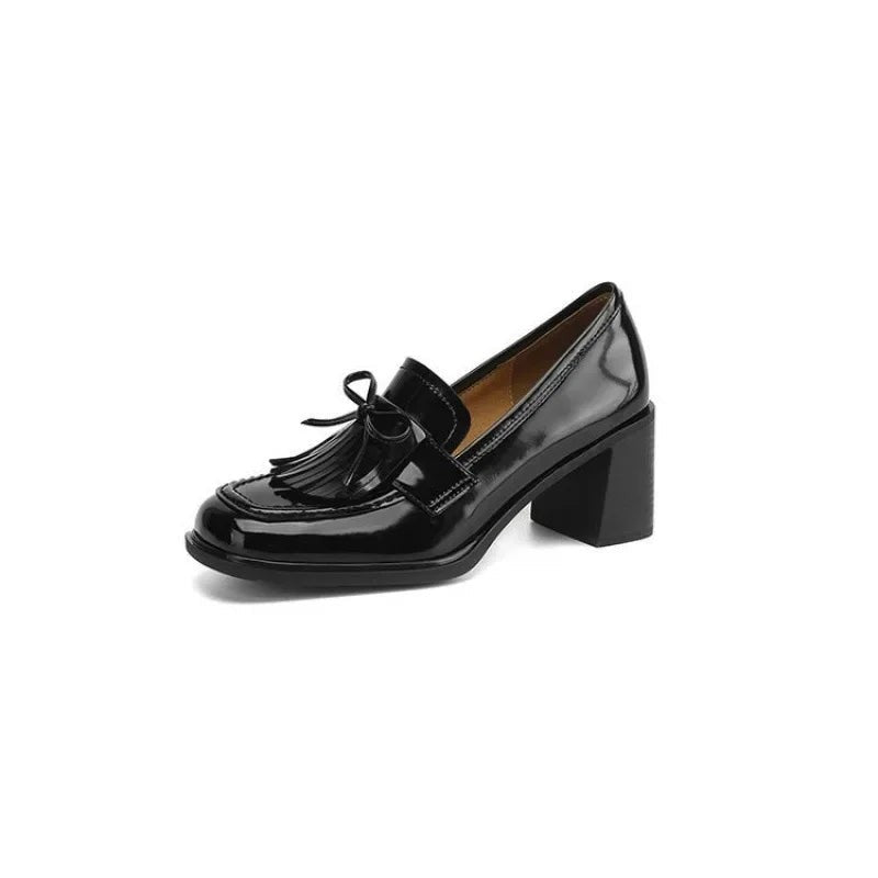 Black patent leather tassel loafer pump on white background