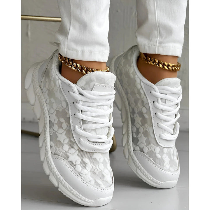 White platform sneakers with textured floral mesh and chunky lugged sole