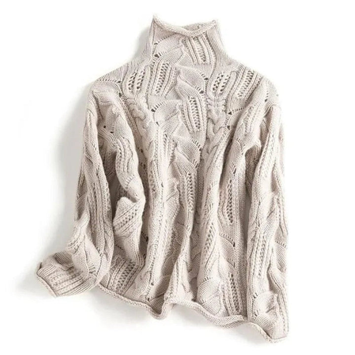 beige cable knit turtleneck sweater laid flat, chunky texture
