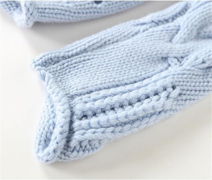 ribbed cuff detail on light blue cable knit pullover sleeve