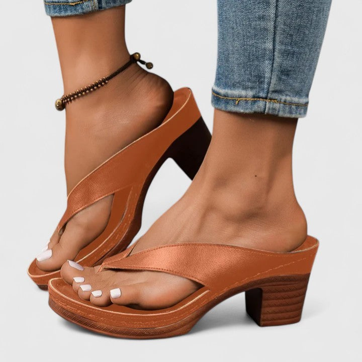 Cognac brown leather flip-flop heels with crisscross strap and platform sole