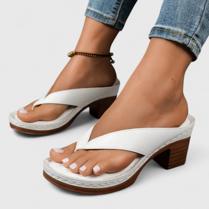 White leather thong sandals with stacked wooden block heel, side view