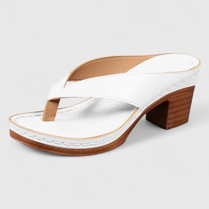 White crisscross thong sandal with platform and wood-tone block heel, studio shot