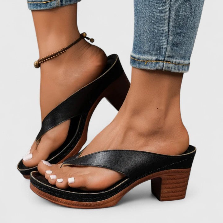 Black crisscross thong sandals with platform sole and stacked block heel